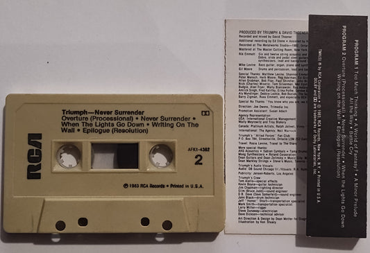 Triumph - "Never Surrender" - CASSETTE TAPE (DOLBY; One side grey, one side tan) VG+/VG+