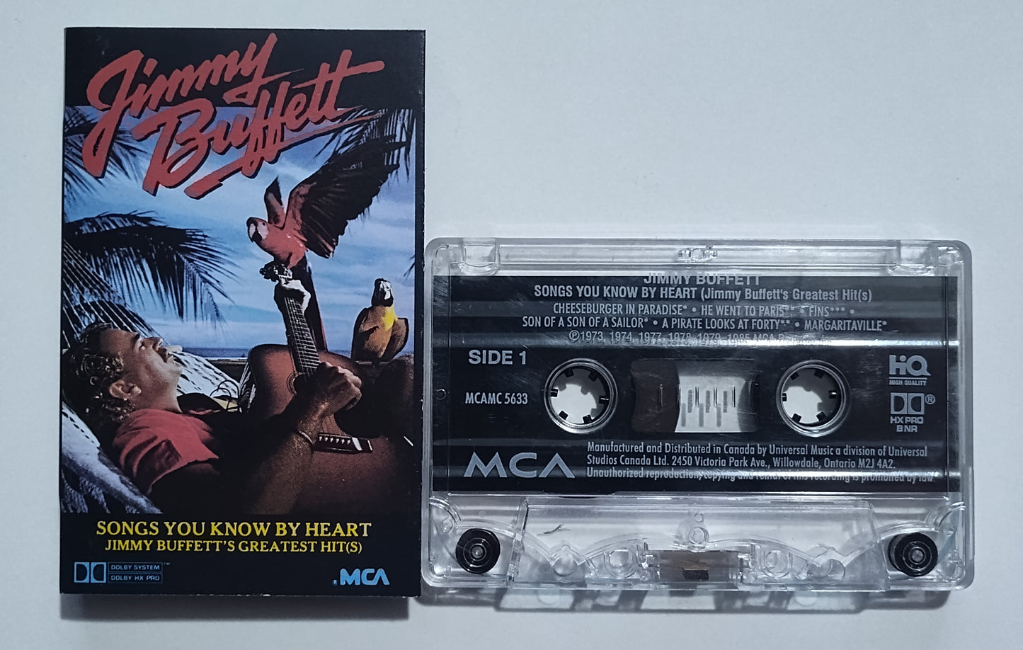 Jimmy Buffett - "Songs You Know By Heart" - CASSETTE TAPE (Canada; clear shell; DOLBY HX PRO B NR) VG/VG