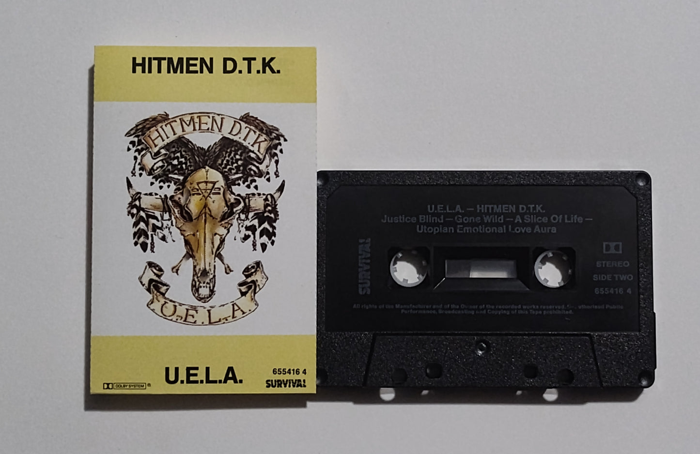 Hitmen D.T.K. - "U.E.L.A."  - CASSETTE TAPE (Australia; black shell; DOLBY Stereo) NM/VG+