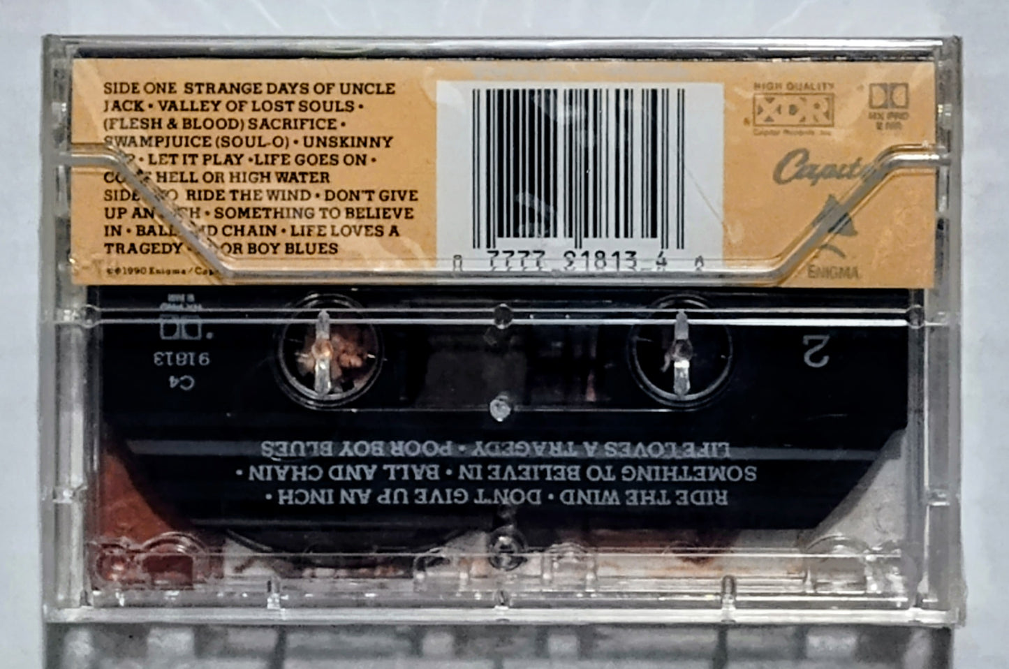 Poison - “Flesh & Blood” - CASSETTE TAPE NM/M (Sealed; large crack in cover; small crack in upper right corner; cellophane slightly ripped in upper left corner)