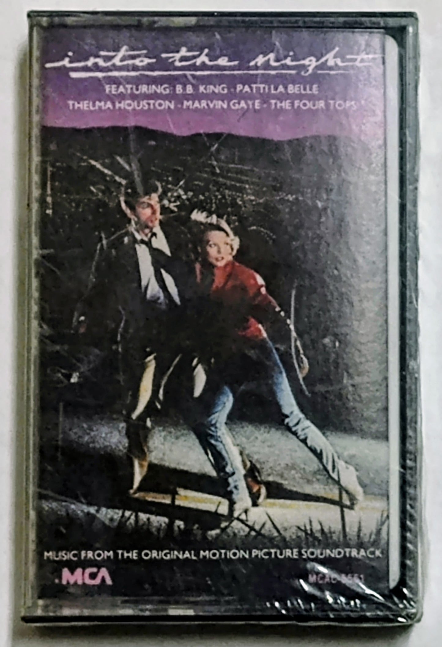 Various Artists - “Into The Night Soundtrack” - CASSETTE TAPE NM/M (Sealed; cracked cover; tears in cellophane)