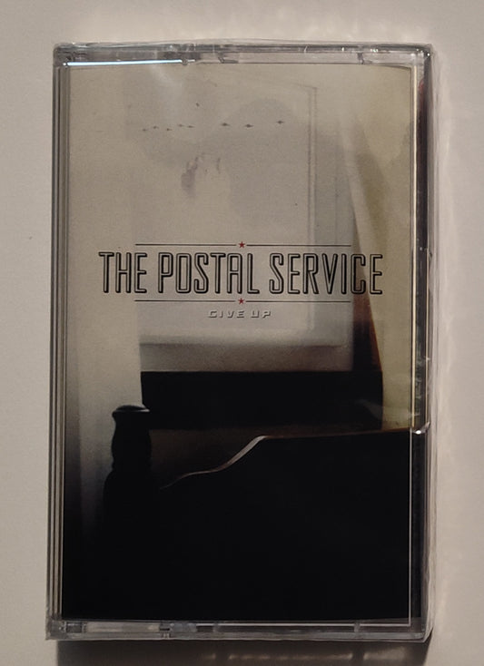 Postal Service, The - "Give Up" - INDIE CASSETTE TAPE (Translucent red shell) M/M (Sealed)
